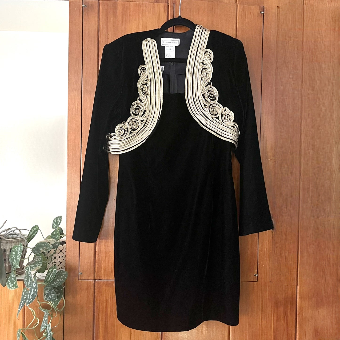 Dress and jacket against wood background