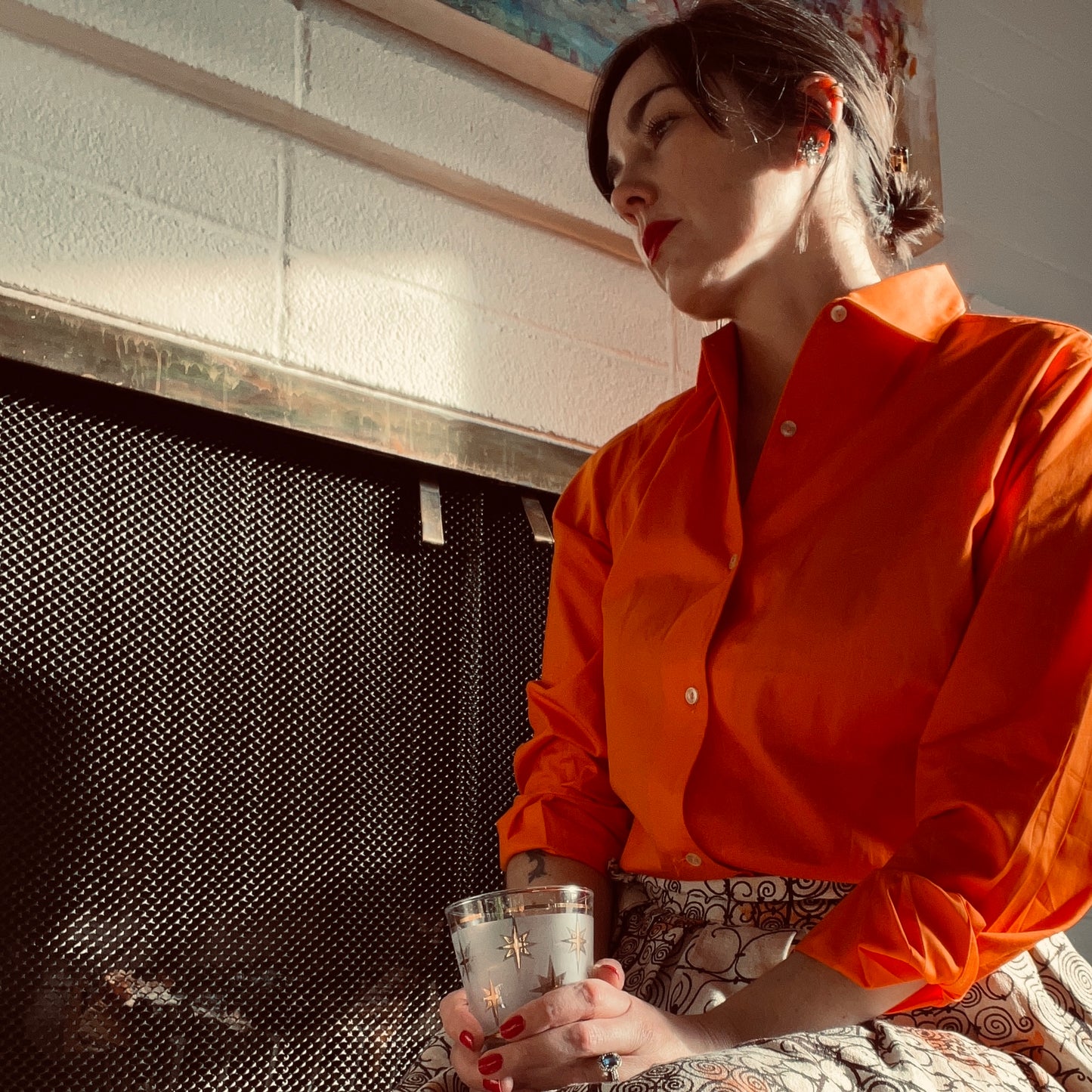 Person sitting at hearth against fireplace