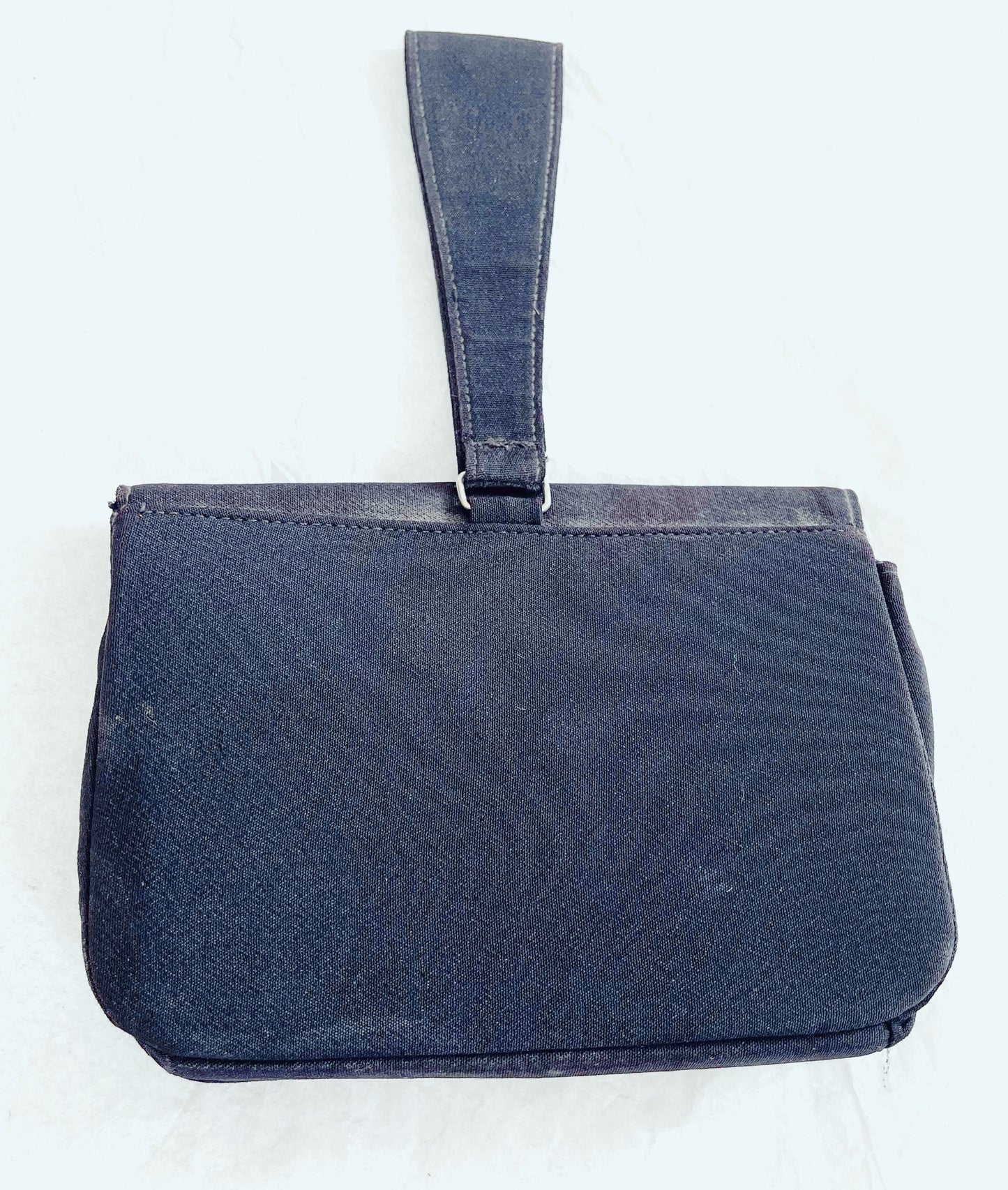 Image of backside of bag against white background.