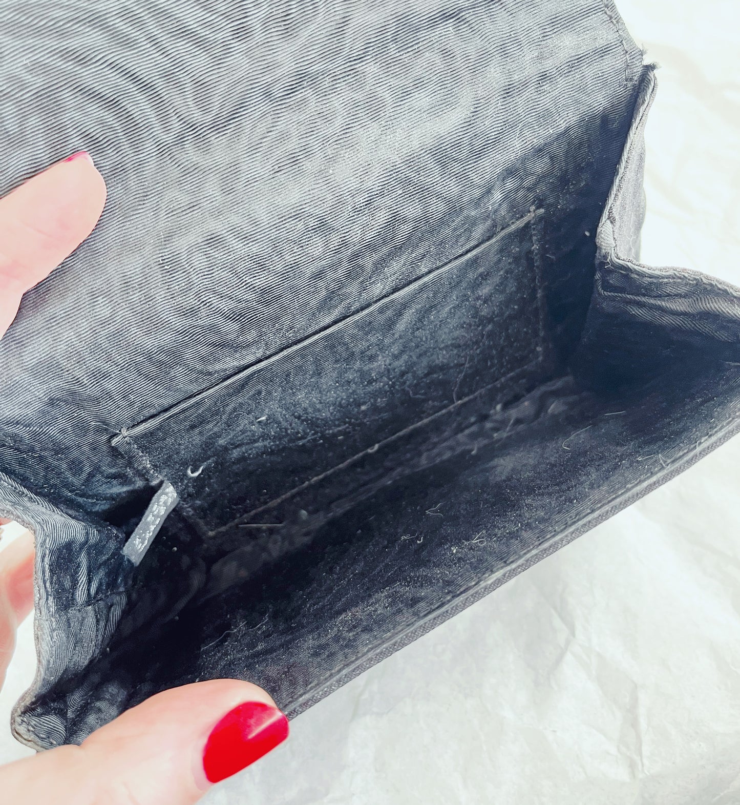 Image of interior of bag, being held open by hand.