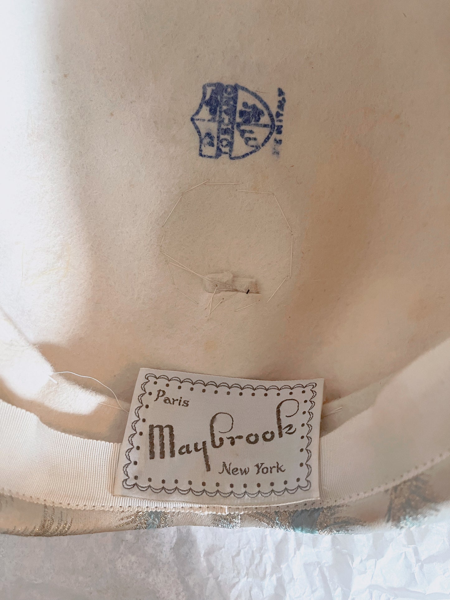 Close up view of inside of hat showing Maybrook tag and stamping.