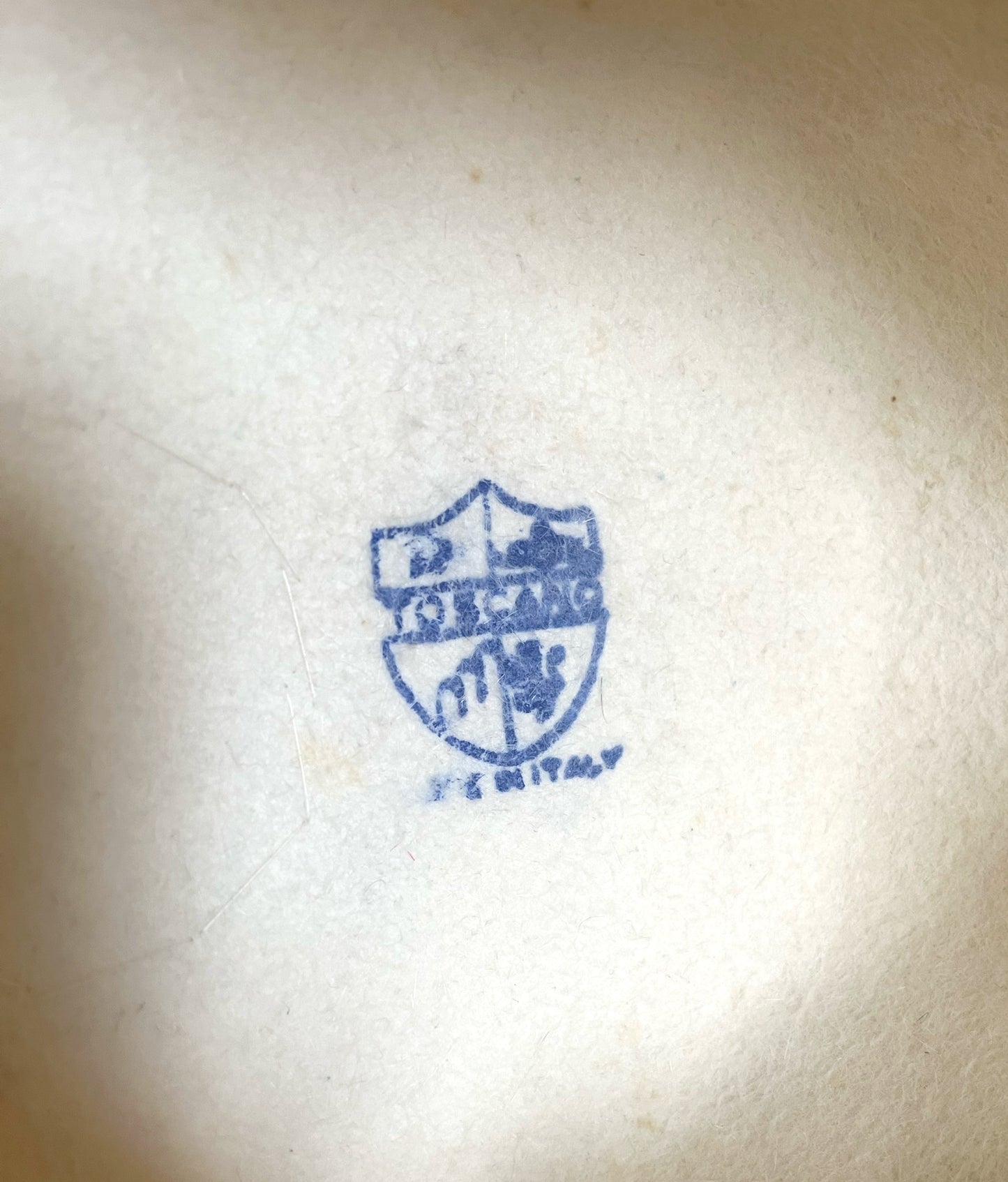 Close up on stamp on interior of hat. Appears to read: Toscano. Made in Italy.