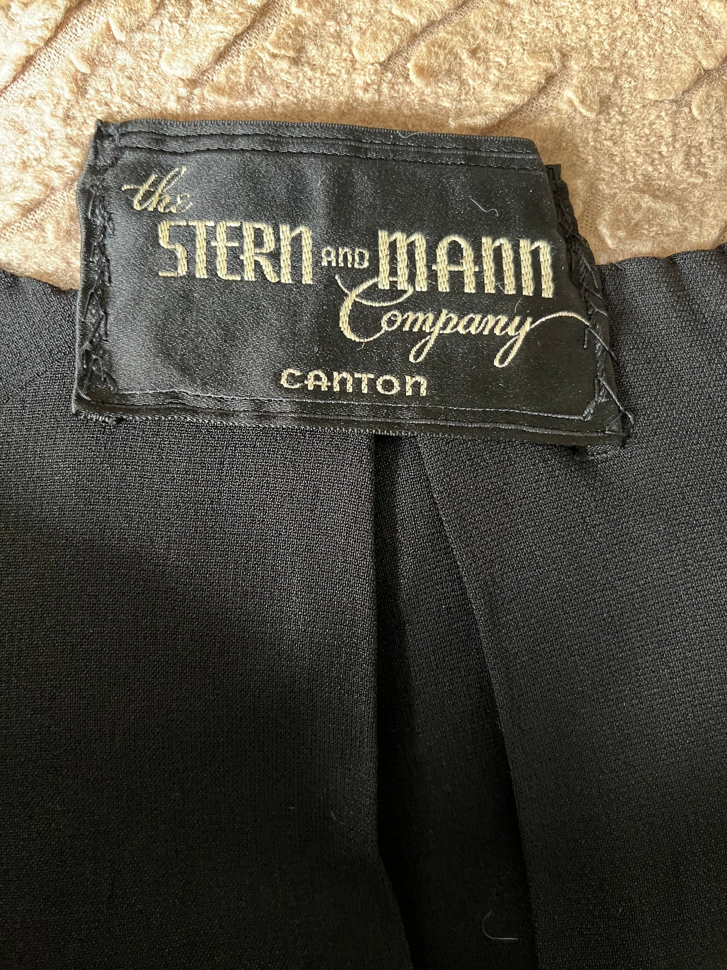 Close up of tag on interior of jacket, reads "The Stern & Mann Company Canton"