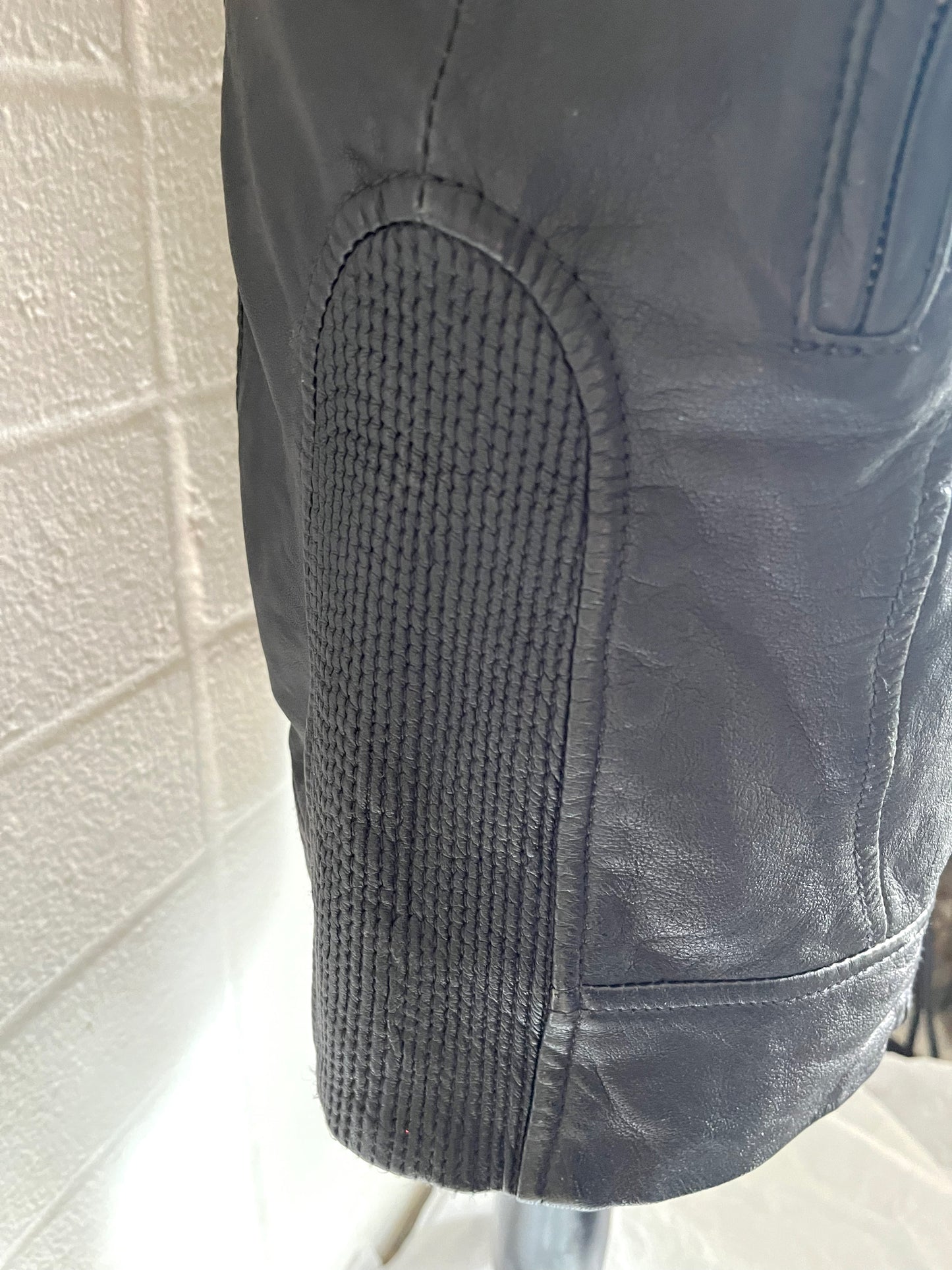 Close up of side panel detail on skirt. White background.