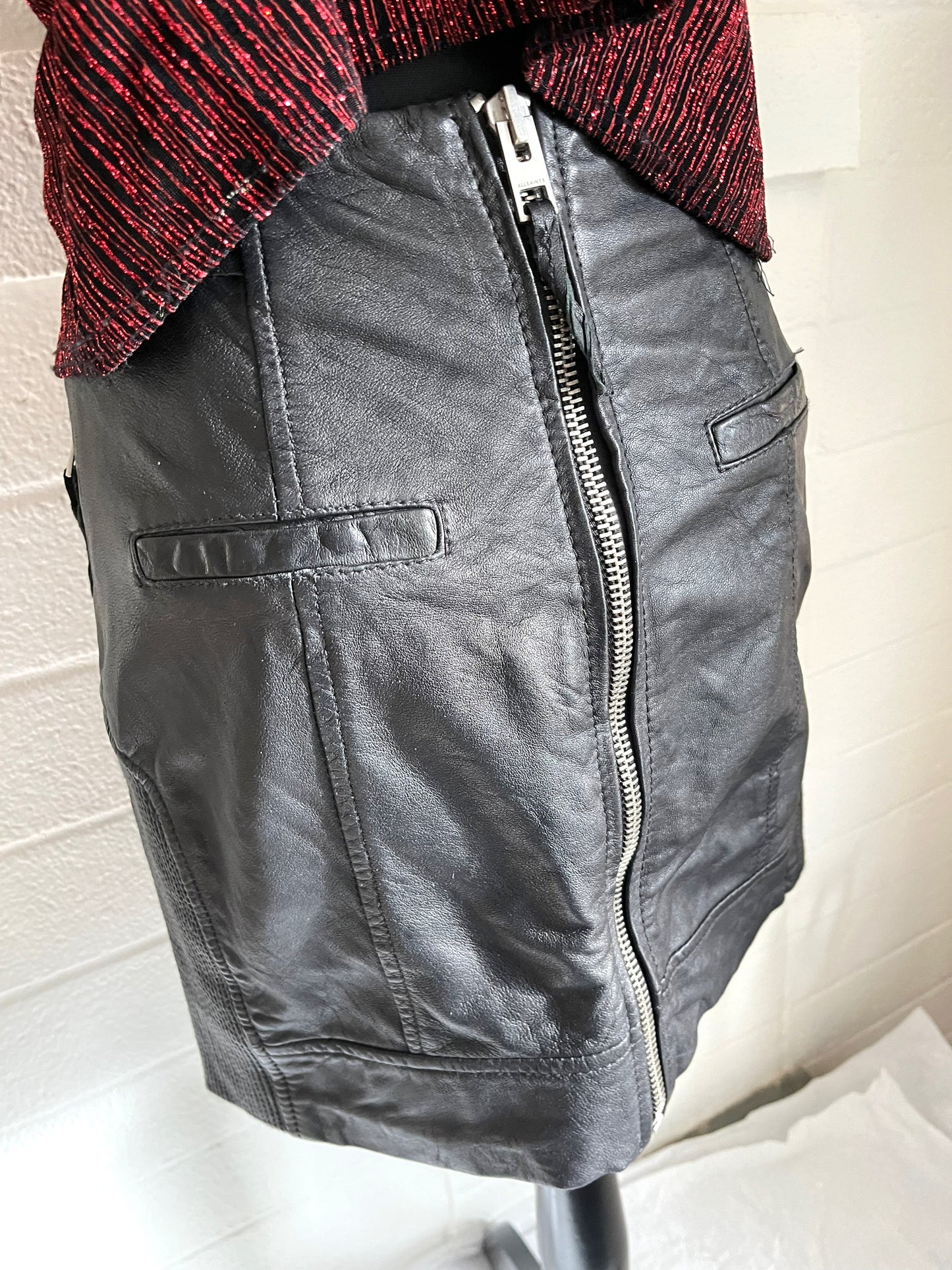 Close up of backside of skirt showing full back zip detailing. White background.
