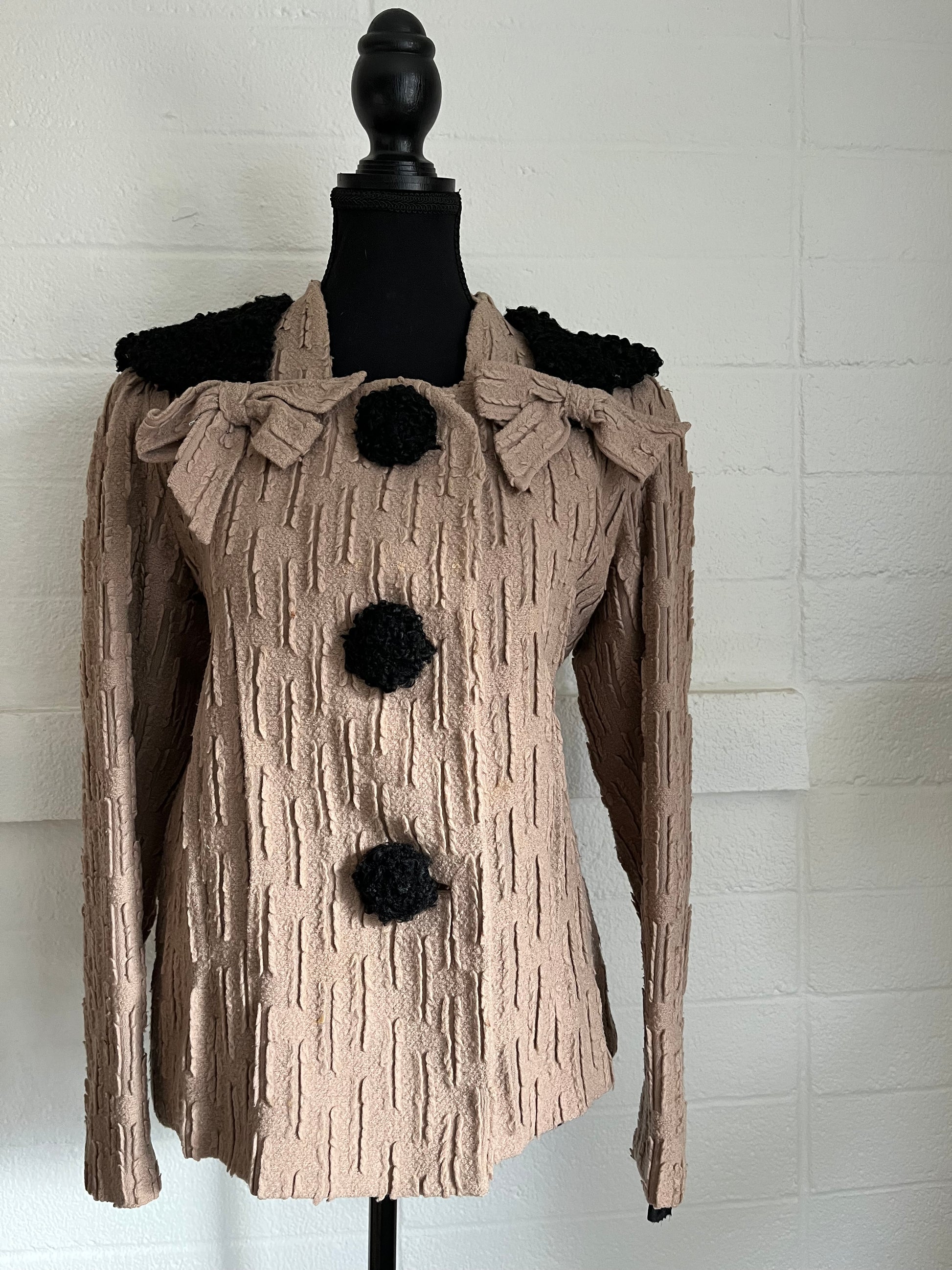 Image of jacket on dressform with white background.  