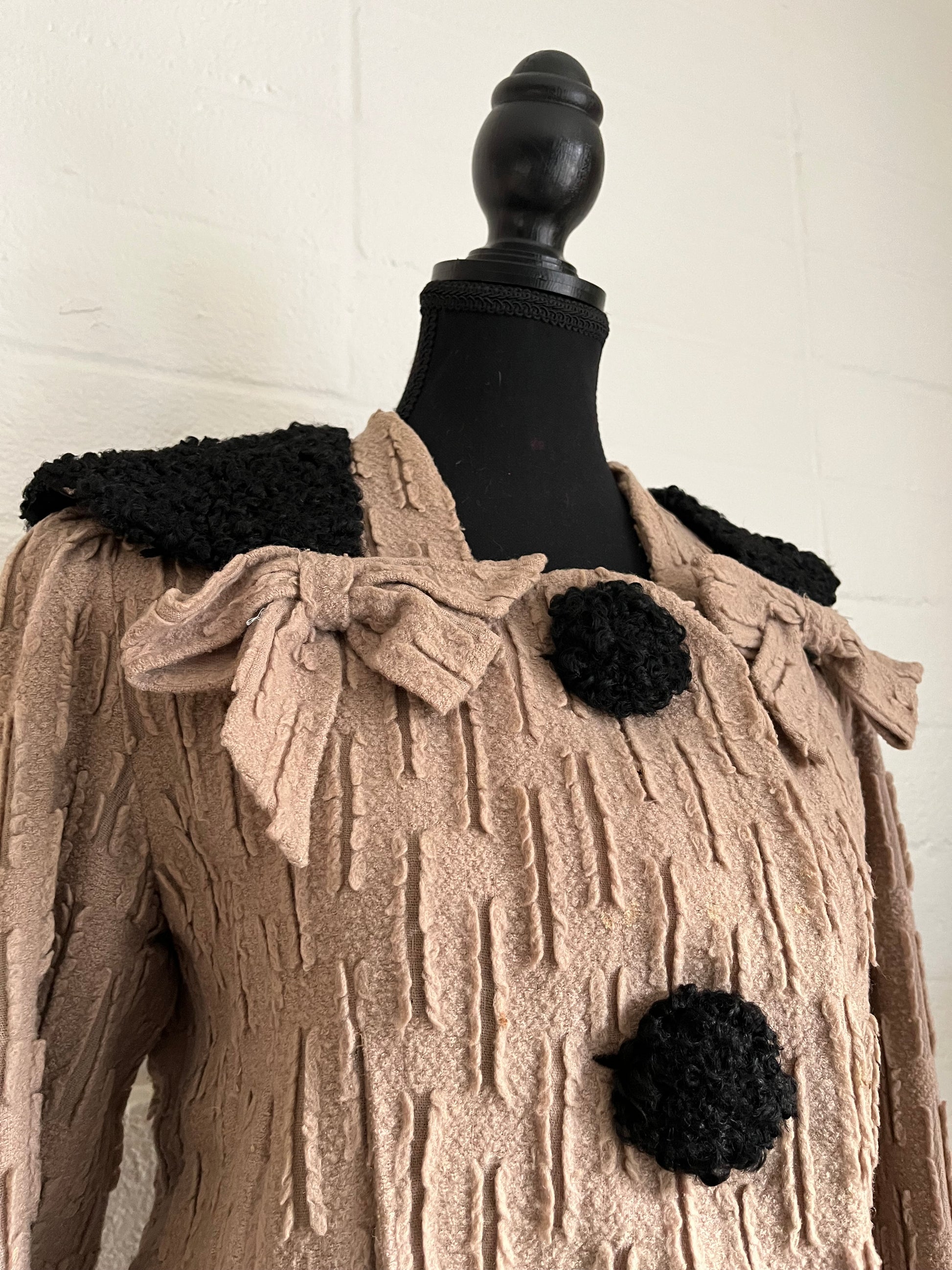Close up angled image of jacket on dressform with white background.  