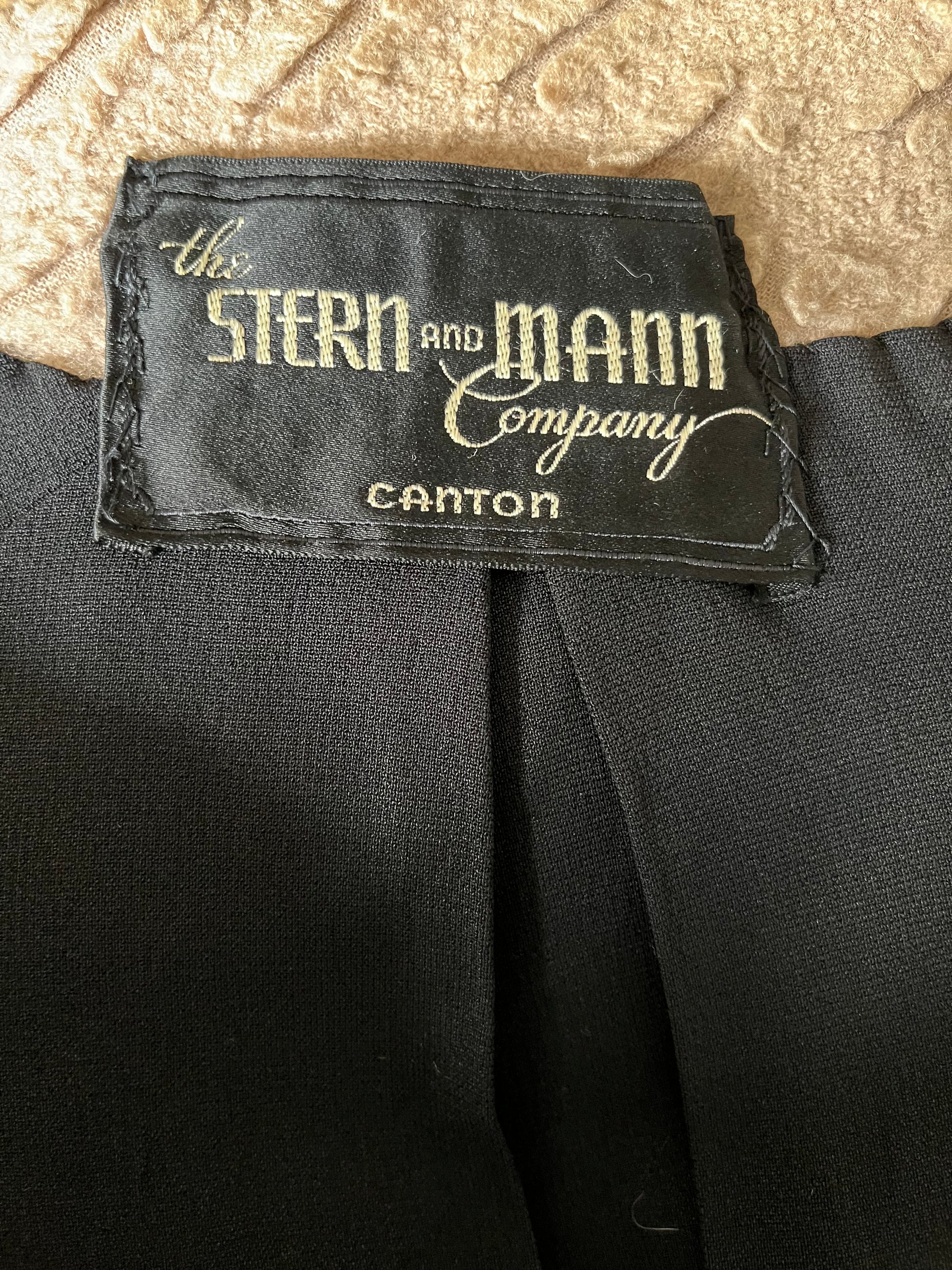 Close up of tag on interior of jacket, reads "The Stern & Mann Company Canton"